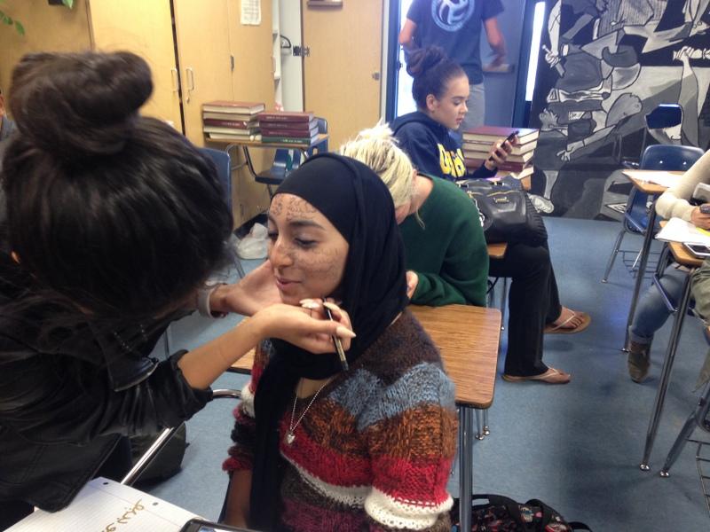 Noorain Naz practices applying her make-up for the Living Art Show.