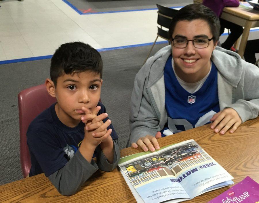 Colt Serrano reads to a member of the Boys and Girls Club.