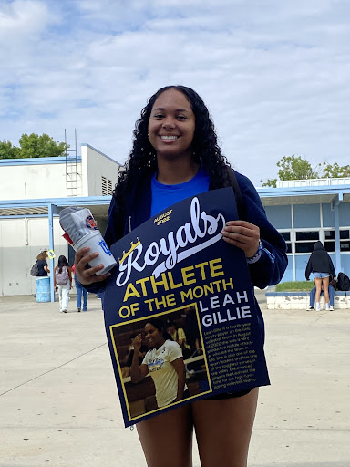 Leah Gille posing with her Athlete of the Month poster